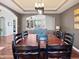Cozy dining room with dark wood furniture and open view into adjacent living area at 1995 Brookfield Ct, Columbus, IN 47201