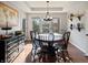 Formal dining room features a round table, tray ceiling, and a large window with backyard views at 1995 Brookfield Ct, Columbus, IN 47201