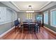 Elegant dining room with tray ceilings, large windows and modern lighting at 1995 Brookfield Ct, Columbus, IN 47201