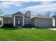 Charming single-story home boasts stone accents, manicured lawn, and inviting front entrance at 1995 Brookfield Ct, Columbus, IN 47201
