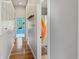 Bright hallway with hardwood floors, convenient built-in cabinets, and a glimpse of a bathroom and bedroom at 1995 Brookfield Ct, Columbus, IN 47201