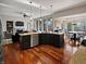 Open kitchen and living area with granite countertops, hardwood floors, and stainless steel appliances at 1995 Brookfield Ct, Columbus, IN 47201