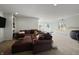 Finished basement living area with neutral walls, carpeted floor, and an oversized sectional sofa at 1995 Brookfield Ct, Columbus, IN 47201