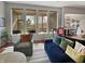 Living room featuring a comfortable sofa, patterned chairs, and large windows overlooking the screened porch at 1995 Brookfield Ct, Columbus, IN 47201