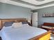 This main bedroom features a bed, bench, shelf, and a soothing color palette for restful sleep at 1995 Brookfield Ct, Columbus, IN 47201
