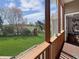 View from the screened porch overlooking a spacious backyard with a lake view and a play set at 1995 Brookfield Ct, Columbus, IN 47201