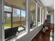 Sunroom with comfortable seating and large windows that offers scenic backyard and screened porch views at 1995 Brookfield Ct, Columbus, IN 47201