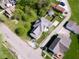 An aerial shot displays the property's location within a residential area, near trees and other homes at 212 W Burnside Ave, Fairland, IN 46126