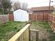 Fenced backyard featuring a shed and lots of greenery at 212 W Burnside Ave, Fairland, IN 46126