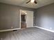 Bedroom with gray walls, neutral carpet and fan, doorway to another room at 212 W Burnside Ave, Fairland, IN 46126