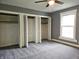 Bedroom featuring neutral carpet, fan, window and three closets at 212 W Burnside Ave, Fairland, IN 46126