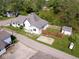 An aerial view reveals the house with a shed, backyard, and proximity to surrounding homes and greenery at 212 W Burnside Ave, Fairland, IN 46126