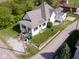 A charming white two-story home featuring black trim, a quaint front porch, and a well-kept lawn at 212 W Burnside Ave, Fairland, IN 46126