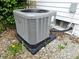 Exterior shot of the home's newer HVAC system, placed on a stone pad near the foundation at 212 W Burnside Ave, Fairland, IN 46126