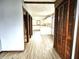 Hallway with hardwood floors and closet with bi-fold doors leading to the kitchen at 212 W Burnside Ave, Fairland, IN 46126