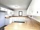 Bright kitchen featuring white cabinets, brick backsplash, and light laminate countertops at 212 W Burnside Ave, Fairland, IN 46126