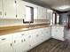 Bright kitchen with white cabinets, laminate countertops and stainless-steel faucet at 212 W Burnside Ave, Fairland, IN 46126