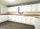 White brick backsplash kitchen features white cabinets and laminate countertops at 212 W Burnside Ave, Fairland, IN 46126
