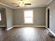 Living room featuring tile floors, gray walls, fan and natural light at 212 W Burnside Ave, Fairland, IN 46126