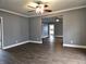Open living room featuring luxury vinyl plank flooring, crown molding, and an open floor plan at 212 W Burnside Ave, Fairland, IN 46126