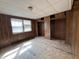 Bedroom with wood paneling, closet, window, and plywood subfloor at 214 S 10Th St, Elwood, IN 46036
