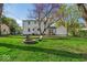 A backyard with a fire pit, chairs, and a view of the house exterior at 2204 Pamela Dr, Indianapolis, IN 46220