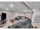 Finished basement with cozy seating area, TV, and staircase at 2204 Pamela Dr, Indianapolis, IN 46220