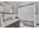 Updated bathroom with white subway tile, dark vanity, and shower with curtain at 2204 Pamela Dr, Indianapolis, IN 46220