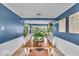 Stylish dining room with blue walls, white wainscoting, and a large wooden table at 2204 Pamela Dr, Indianapolis, IN 46220