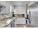 Well-lit kitchen with granite countertops, stainless steel appliances and ample cabinet storage at 2204 Pamela Dr, Indianapolis, IN 46220