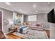 Comfortable living room with hardwood floors, a stylish sectional, and a large window at 2204 Pamela Dr, Indianapolis, IN 46220