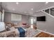 Relaxing living room with a large sectional, hardwood floors, and modern decor at 2204 Pamela Dr, Indianapolis, IN 46220