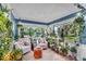 Sunroom with armchairs surrounded by an abundance of natural light and lush greenery at 2204 Pamela Dr, Indianapolis, IN 46220
