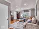 Cozy living room with hardwood floors, a plush sectional sofa, and ample natural light at 2204 Pamela Dr, Indianapolis, IN 46220