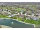 Aerial view showcasing the home's proximity to a scenic pond, a golf course, and mature trees at 2446 Quiet Way, Indianapolis, IN 46239