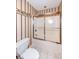 Bathroom featuring striped wallpaper, elephant border, and a shower-tub with sliding glass doors at 2446 Quiet Way, Indianapolis, IN 46239