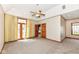 Spacious carpeted bedroom with a ceiling fan and multiple entry doors at 2446 Quiet Way, Indianapolis, IN 46239
