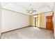 Large bedroom featuring a ceiling fan, carpeted floors, and a glass door leading to a balcony at 2446 Quiet Way, Indianapolis, IN 46239