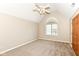 Bedroom featuring carpeted floors, light-colored walls, and a single arched window at 2446 Quiet Way, Indianapolis, IN 46239