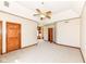 Large carpeted bedroom with a ceiling fan and multiple entry doors at 2446 Quiet Way, Indianapolis, IN 46239