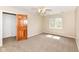 Bedroom featuring a ceiling fan, carpet, and a window offering natural light at 2446 Quiet Way, Indianapolis, IN 46239