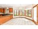 Bright dining area with a bay window, tiled floor, and wood trim, adjacent to the kitchen at 2446 Quiet Way, Indianapolis, IN 46239