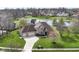 A beautiful brick house with a large lawn sits next to a pond at 2446 Quiet Way, Indianapolis, IN 46239