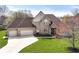 A charming home with a well-manicured lawn and three-car garage at 2446 Quiet Way, Indianapolis, IN 46239