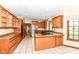 Spacious kitchen boasts stainless steel appliances, granite countertops, wood cabinets, and tiled floors at 2446 Quiet Way, Indianapolis, IN 46239