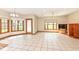 Bright living room featuring tiled floors, a ceiling fan, and natural light from large windows at 2446 Quiet Way, Indianapolis, IN 46239