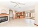 Spacious living room with a fireplace, tiled floors, and an open layout connecting to the kitchen at 2446 Quiet Way, Indianapolis, IN 46239