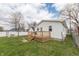 View of the deck and backyard of this home with a grass lawn and partial privacy fence at 282 N Mapleton St, Columbus, IN 47201