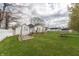 Home's backyard with deck, swing, picnic table, and partially fenced yard at 282 N Mapleton St, Columbus, IN 47201