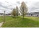 Manicured backyard with large grassy area and picnic table at 282 N Mapleton St, Columbus, IN 47201